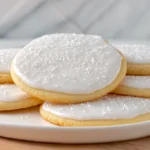 sugar cookie recipe, iced with white icing and white sprinkles