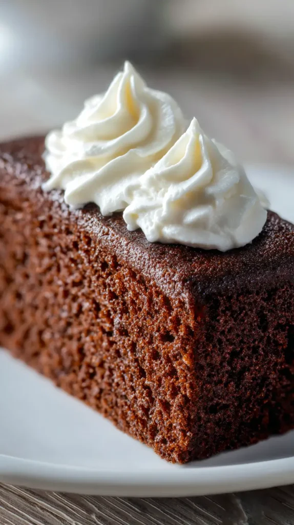 gingerbread cake slice with two dollops of whip cream