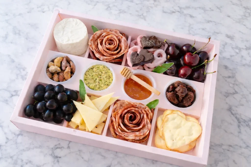 A snackle box with organized sections of salty snacks, sweet treats, and finger foods