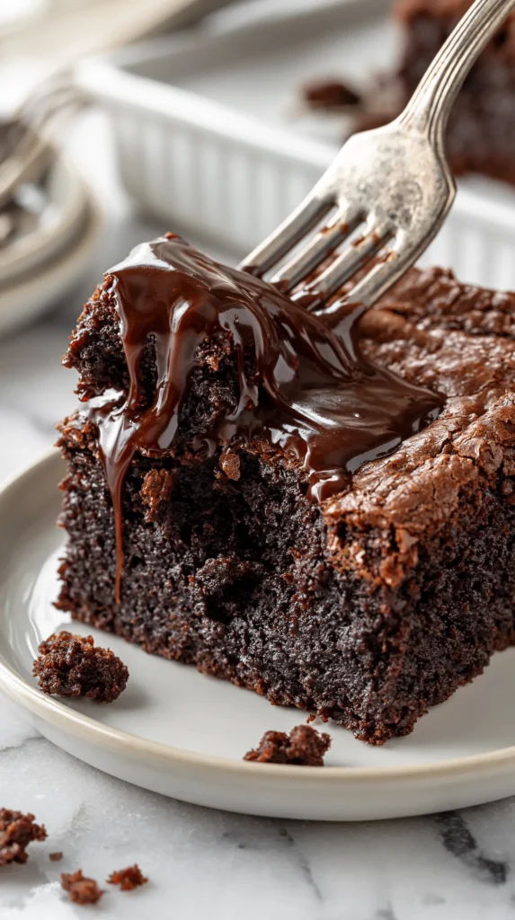 Hyper-realistic vertical photo of a silver fork lifting a gooey bite from a single dense fudgy hot fudge brownie on a small white ceramic plate, glossy warm hot fudge dripping from the brownie and stretching slightly from the lifted bite, moist dark chocolate crumb visible, slightly crackly brownie top, a few soft chocolate crumbs scattered on the plate and white marble countertop, bright white kitchen background, soft natural window light, editorial dessert photography, rich realistic chocolate texture, shallow depth of field, crisp focus on the lifted bite and front of the brownie, cozy bakery-style dessert styling, no people, no hands, no text, no logos, no watermark